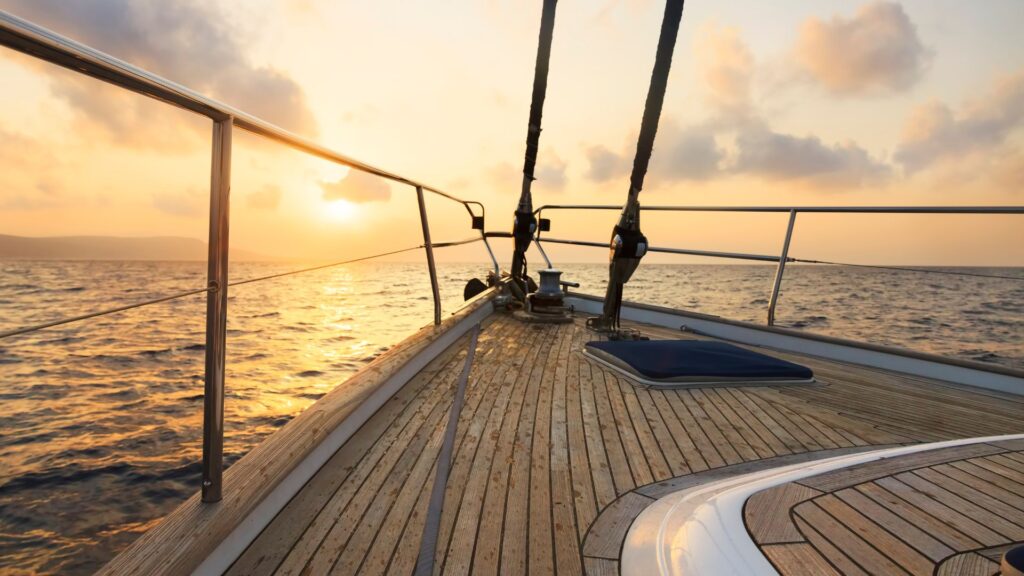 Yacht sailing at sunset